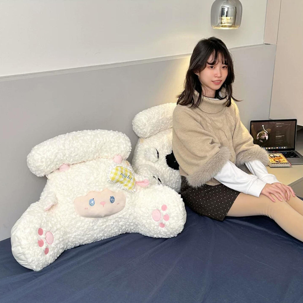 Adorable lamb body pillow on a reading chair, soft stuffed sheep plush for cozy self-care, napping and comfort after a long day