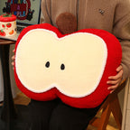 Person hugging the large red apple plush pillow to show its generous 57x40cm size, plump PP cotton filling, and soft red fleece apple body