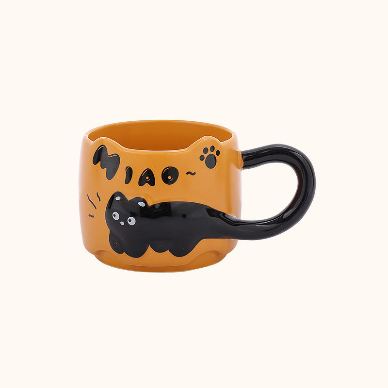 Orange black cat ceramic mug on a plain cream background - 3D relief black cat draped around the body, cat-ear rim, glossy black tail handle, and hand-painted MIAO lettering