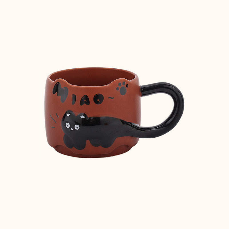 Brick red black cat ceramic mug on a plain cream background - 3D relief black cat draped around the body, cat-ear rim, glossy black tail handle, and hand-painted MIAO lettering