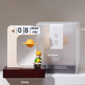 Floating planet perpetual calendar with the reading prince figurine - cream arch frame on a walnut wooden base, a golden Saturn floating mid-air, flip cards showing 08 MAR FRI, next to its frosted gift box, 12x15.2cm size annotations