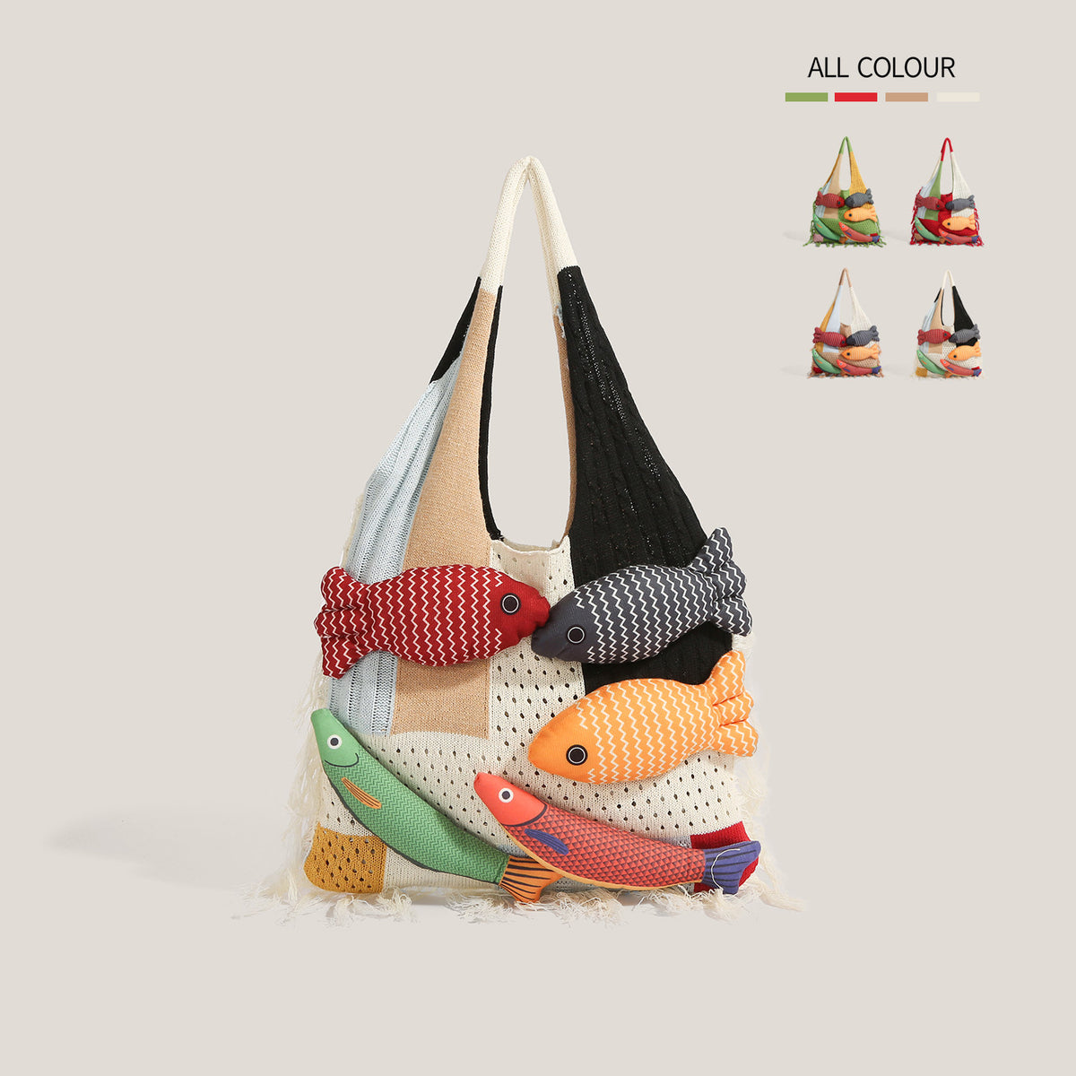 White knitted fish tote bag on a beige background - ivory, black, navy and camel patchwork knit panels, five stuffed 3D fish appliques with googly eyes, cream fringe at the hem, ALL COLOUR swatch chart in the corner
