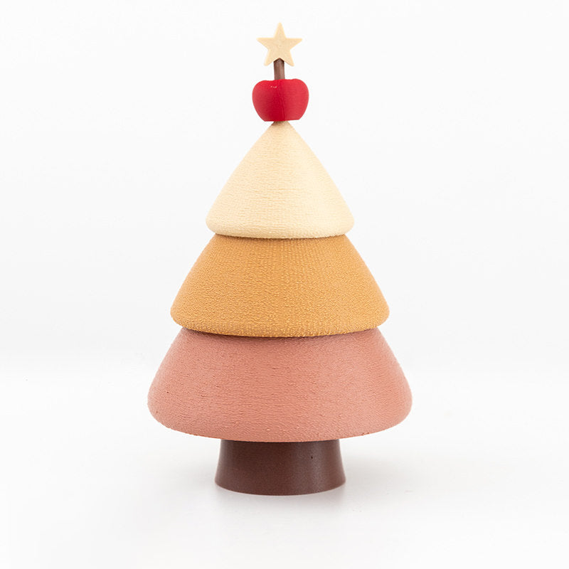 Cinnamon Christmas tree jewelry box on a white background - 3D printed stacking tree in cream, caramel and dusty rose tiers with brown trunk, red apple and wooden star topper, matte frosted PLA finish