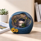 Van Gogh art night light on a wooden desk with a succulent and photo book around - blue matte resin sphere with glowing Starry Night interior, chibi painter figure with dark curls and green coat, sculpted sunflowers on the rim