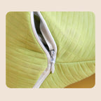 Close-up of the zipper on the green triangle neck pillow - white zipper with fabric pull tab on the lime green quilted cover, showing the removable washable pillowcase seam
