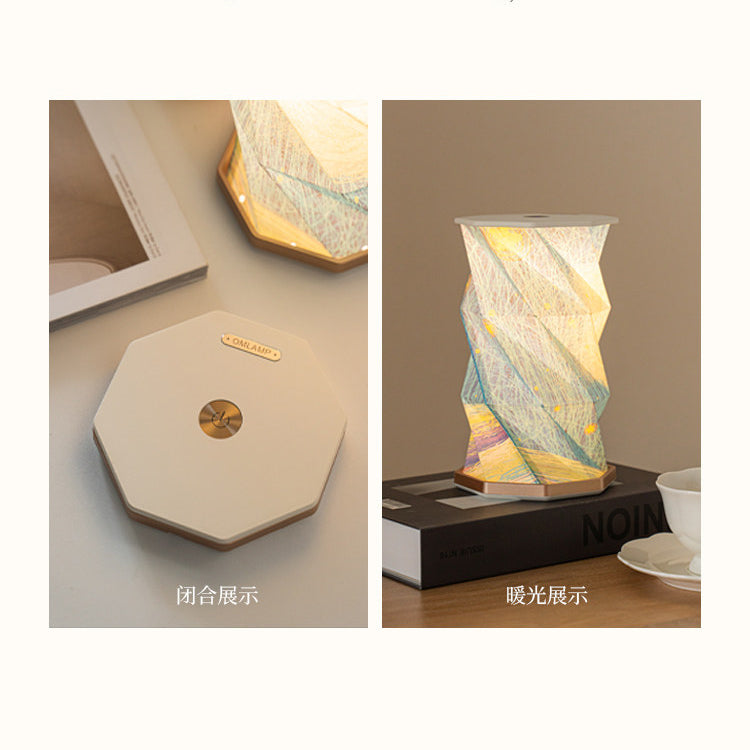 Two-panel comparison of the Starry Night folding lamp - left shows the lamp fully folded flat as an octagonal slab with OMLAMP gold plate and dimmer button, right shows it unfolded and glowing warm on a book, Chinese captions below each panel