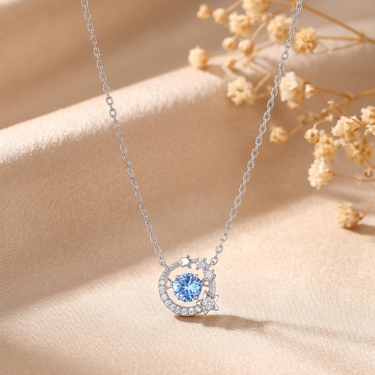 Dancing Heart sterling silver necklace with blue cubic zirconia moon and star pendant