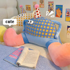 Soft stuffed monster-shaped character pillow with embroidered eyes and smile, decorative plushie cushion for reading nook and bedroom